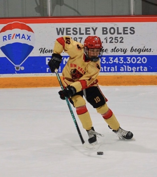 Young Bow Valley Yeti player carrying the puck